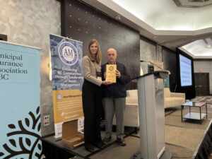 Laura Hardiman accepting a 2025 #OurAssetsMatter Award from Wally Wells at the 2025 AMBC Conference.